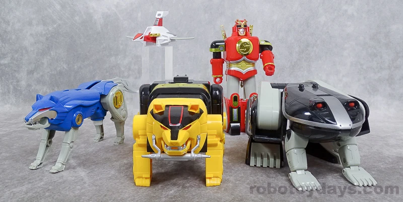 Separate original DX beasts: a blue wolf, white crane, upright red ape, yellow bear and black frog.