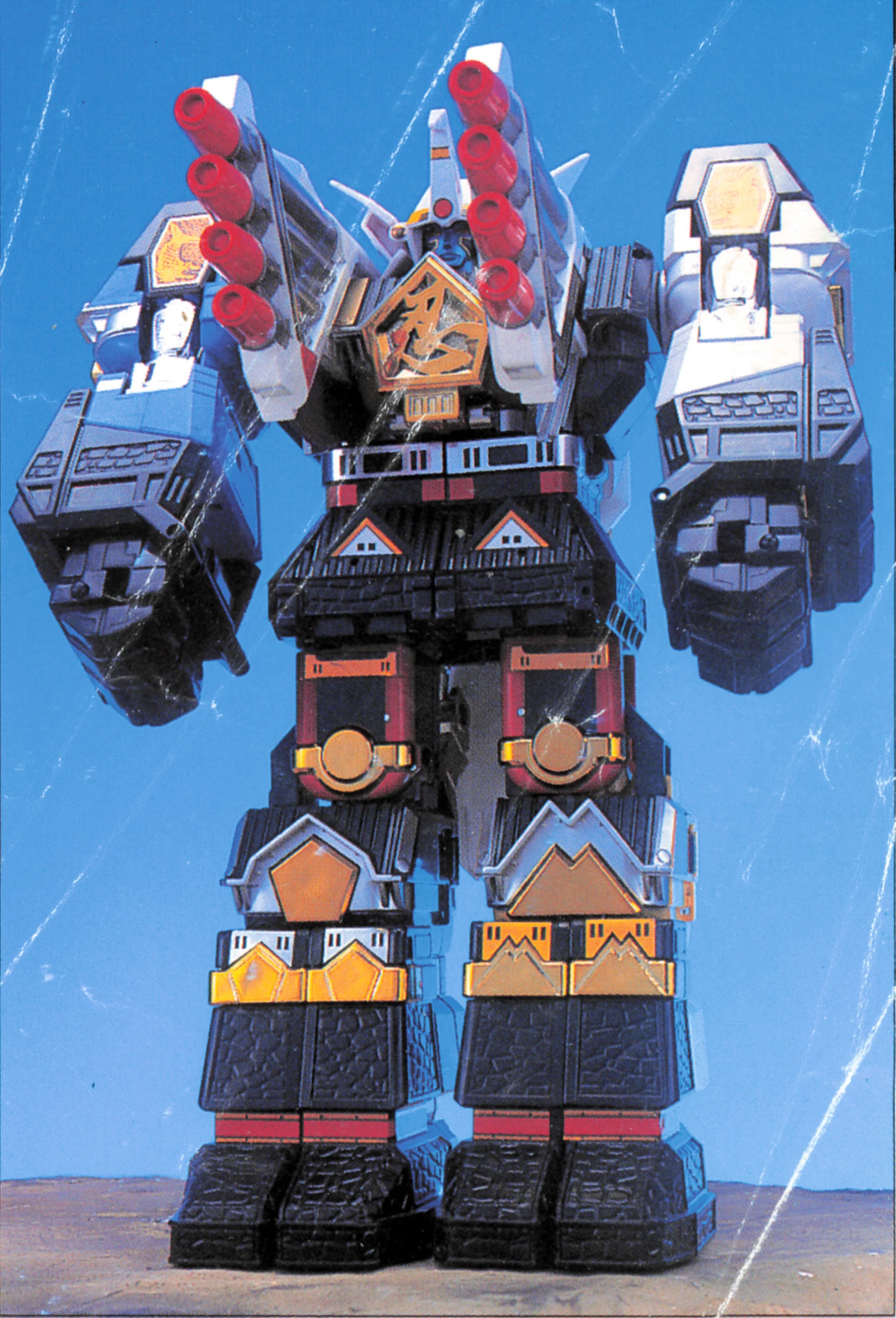 Bandai’s DX Tsubasamaru combined with DX Muteki Shogun, with two banks of four red cannon barrels pointing upward beside the robot’s head.