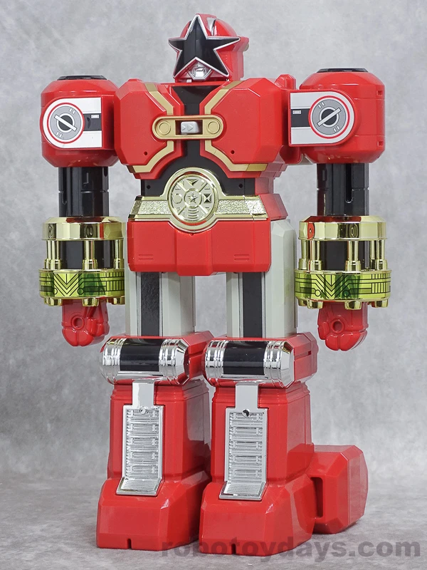 Original Japanese Bandai DX Red Puncher toy standing with its arms lowered, retaining the red body, gold forearm sleeves, black star visor and silver legs.