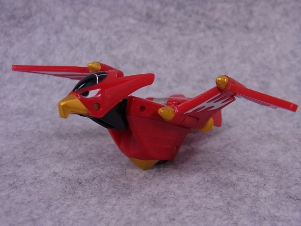 Original DX Hurricane Hawk toy with red wings, white markings and a yellow beak.