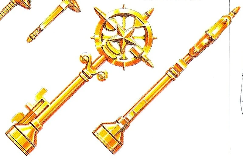 Gold Legendary Key design in front and side views, with a circular spoke-like bow, narrow shaft and broad rectangular tip.