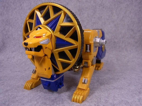 Original DX Hurricane Leon toy on four legs, with a yellow face inside a large circular mane.