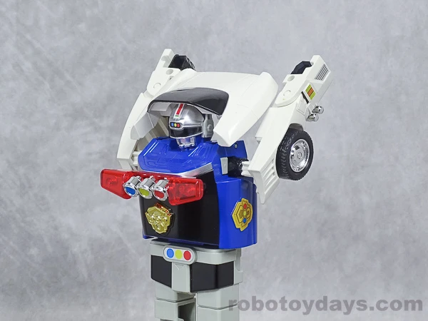Original DX Sirender upright with its white rear car panels raised above its shoulders during transformation.