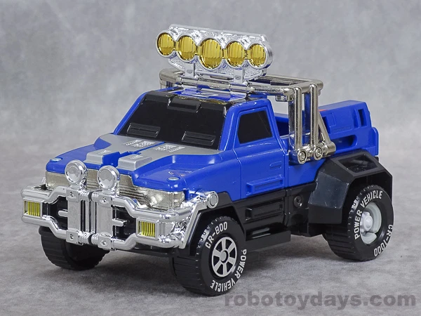 Original DX Blue Vehicle pickup with plated roof lamps and front grille guard.